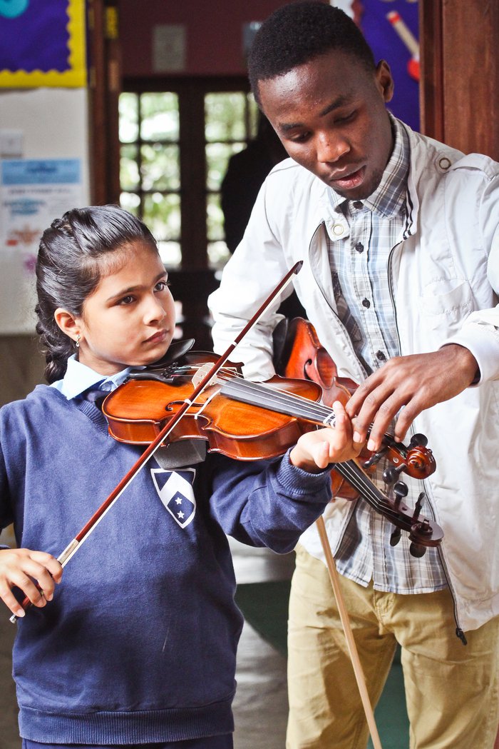 Child being taught the violin